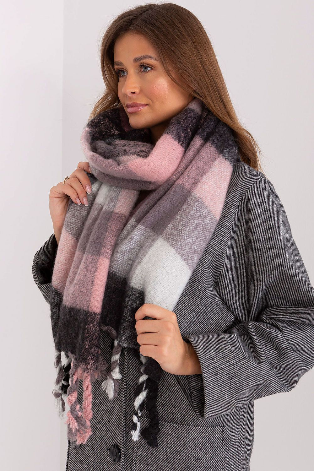 Playful plaid scarf in shades of pink, black, grey, and white.
