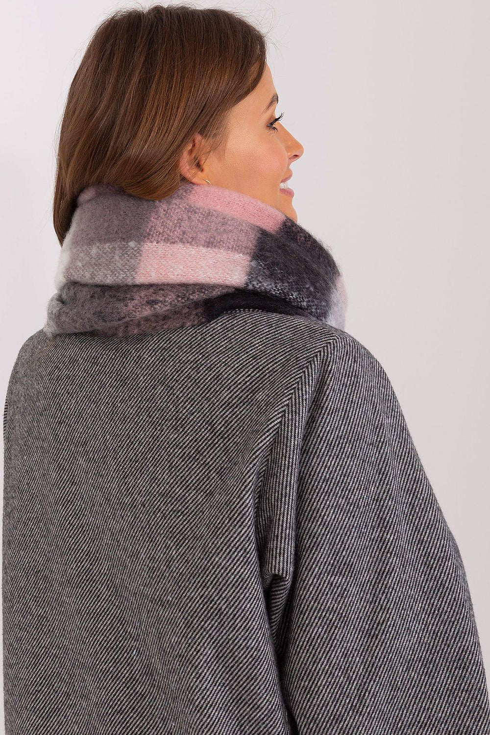 Playful plaid scarf in shades of pink, black, grey, and white.