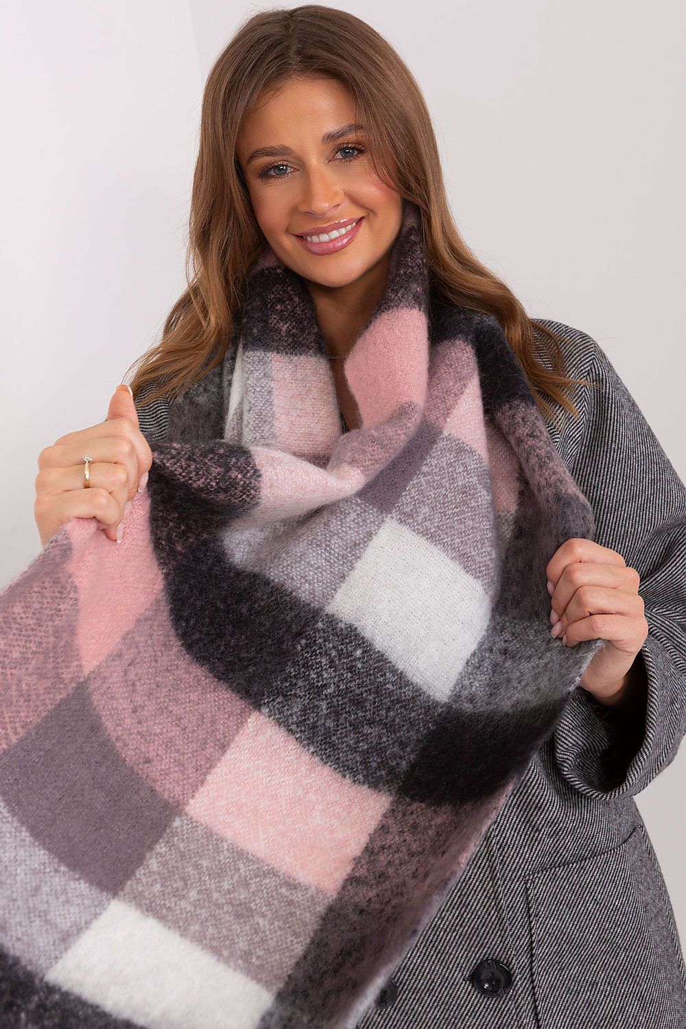 Playful plaid scarf in shades of pink, black, grey, and white.