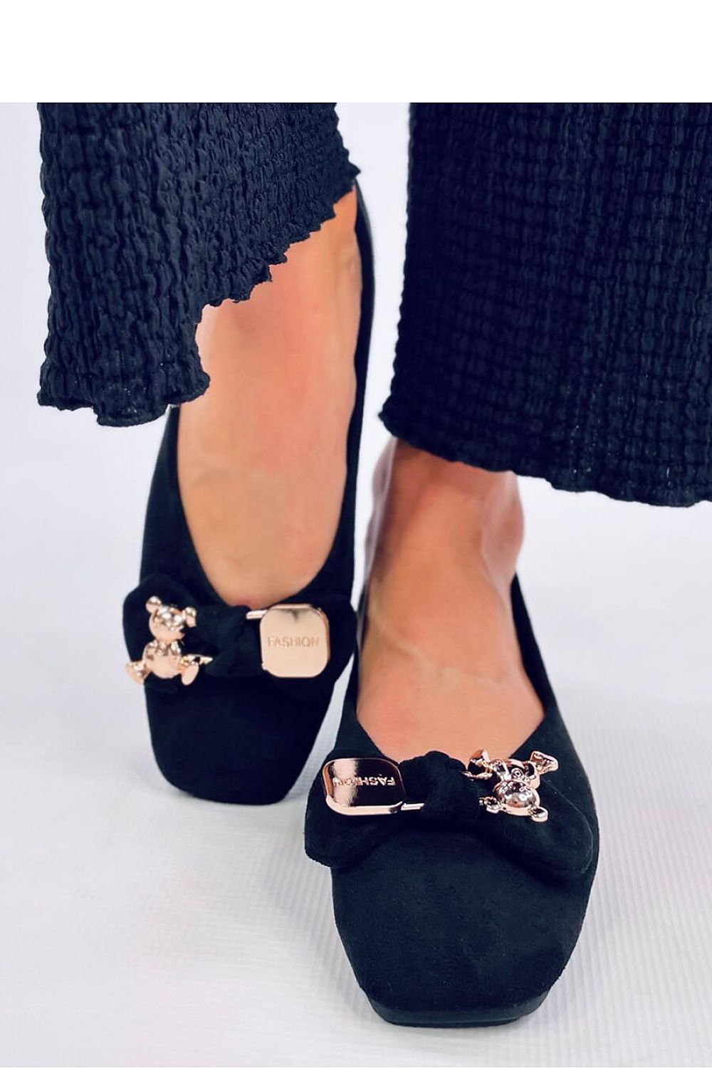 A bow with a gold safety pin and teddy bear Ballet flats